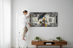 Lifestyle shot - Woman hanging canvas